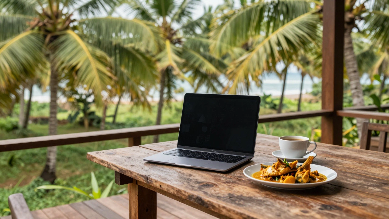A laptop and Goan food on a terrace overlooking a tropical coconut grove.
