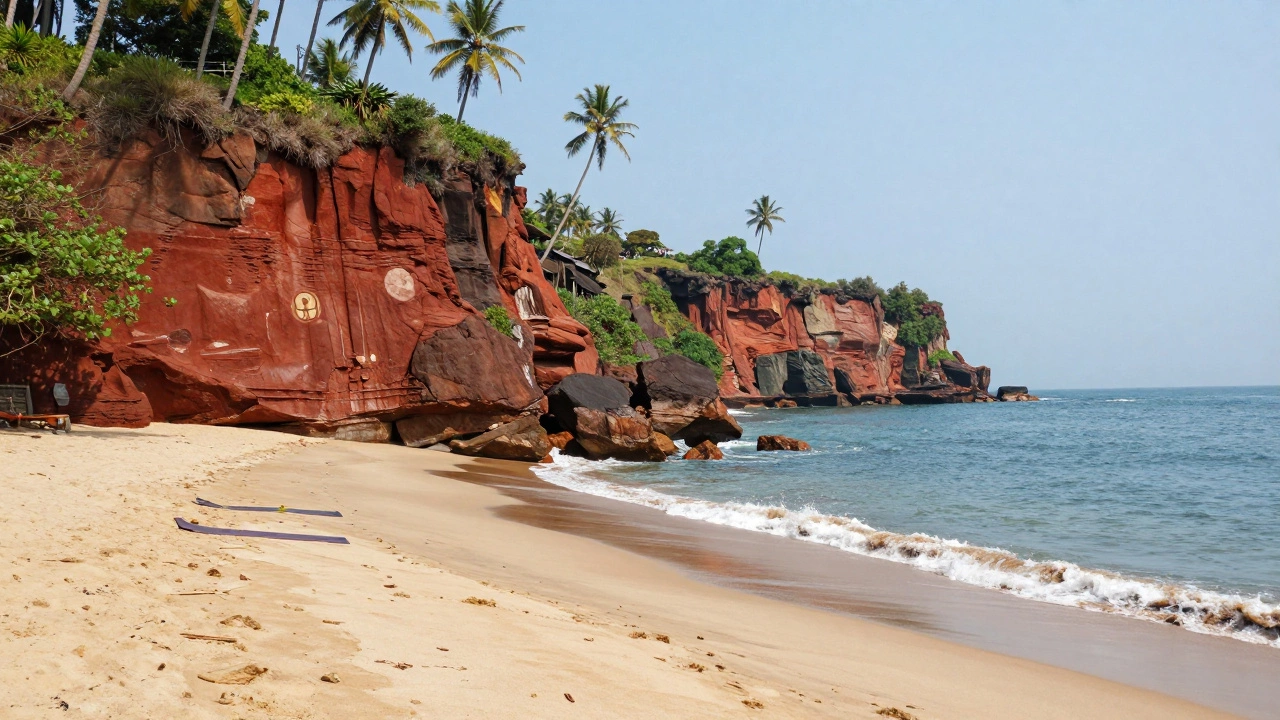 Red laterite cliffs overlooking clean sands and yoga spots at Varkala Beach, Kerala