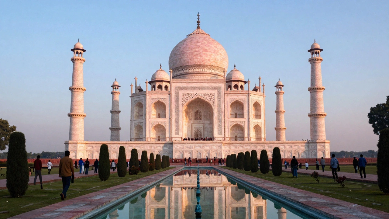 Taj Mahal in India glowing at sunrise with visitors nearby